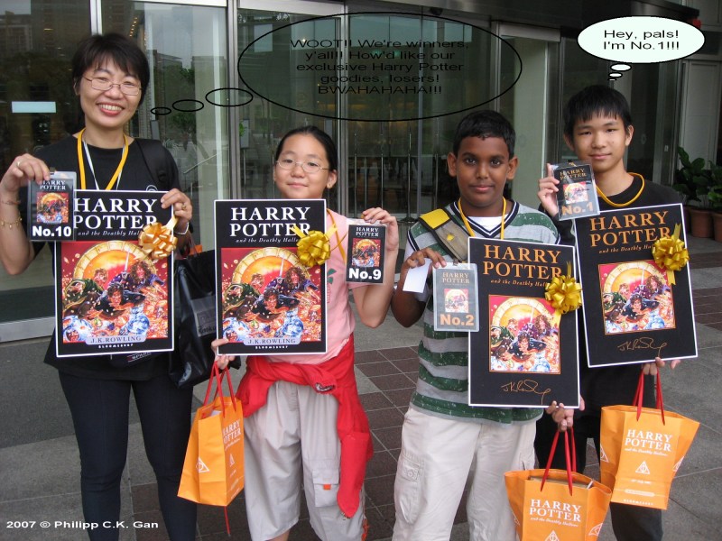 Lucky winners Donovan Liew (far right), Daniel Rajasingham Subramaniam (second from right), Dayana Liew (third from right) and Lee Swee Bee (far left) show off the goodies they walked away with after waiting in line with hundreds of others - all wanting to be the first few in KL to get their hands on the book.  